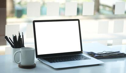 Modern workspace with computer with blank screen and equipment on white table.Blank screen for your information.