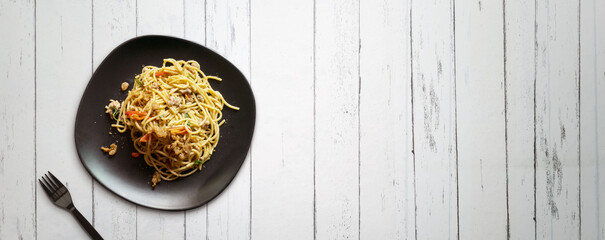 Spaghetti and fork  on wood table