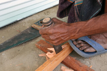 a boat restoration worker with machine