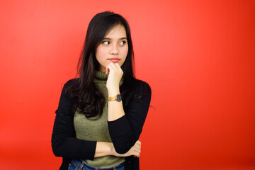 Portrait of Young beautiful asian women using black sweater with red isolated background