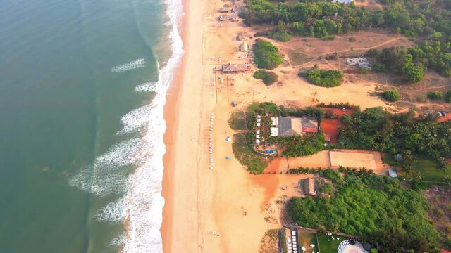 goa Sinquerim Beach drone bird's eye view drone coming down towards beachzoom in.