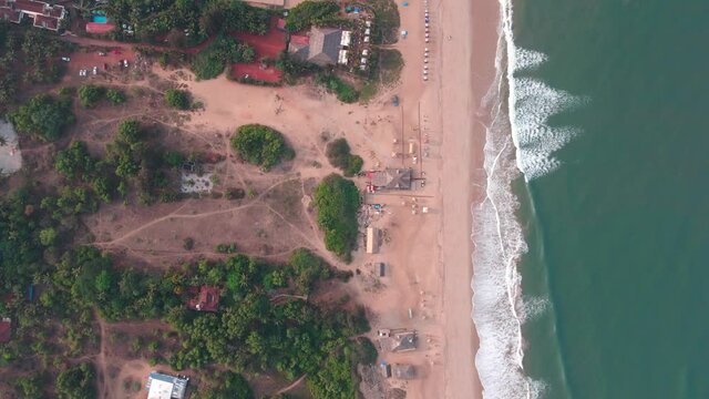 goa Sinquerim Beach drone shot shack view from the beach to waves top birds-eye view  extreme top cinematic