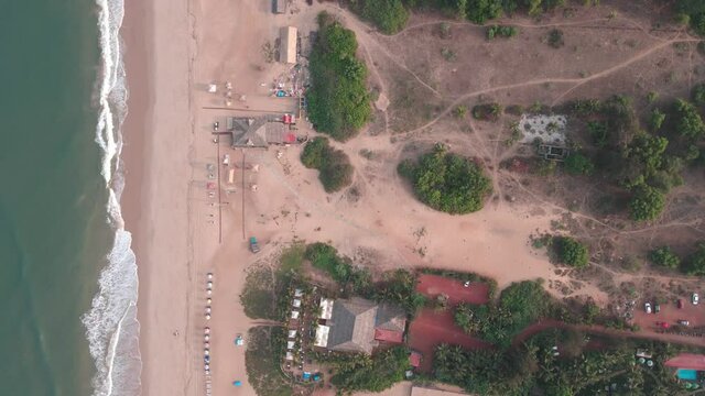 goa Sinquerim Beach drone shot shack view from the beach to waves top birds-eye view  extreme top