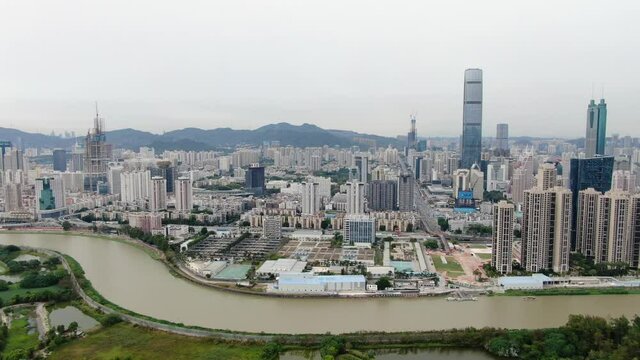 Aerial view over Shenzhen cityscape with massive urban development and skyscrapers.