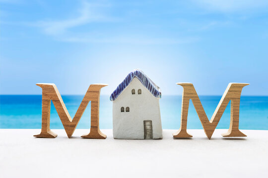 Mother's day card background idea, Happy mother's day, wooden font and vintage style ceramic house over blue sea and clear sky background
