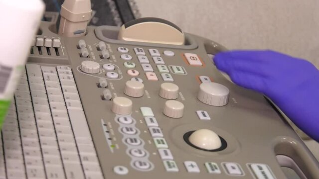 ultrasound machine doctor's hand usg investigation. Doctor using ultrasound machine at work
