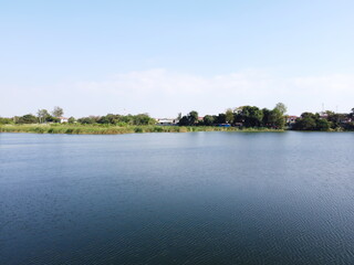 Big lake in countryside near village.