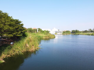 Obraz premium Big lake in countryside near village.