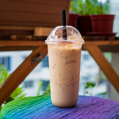 Iced blended caramel coffee topped with crushed caramel biscoff in plastic glass. Hot season refreshing drinks.