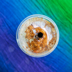 Iced blended caramel coffee topped with crushed caramel biscoff in plastic glass. Hot season refreshing drinks.