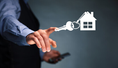 man holding phone with house key icon