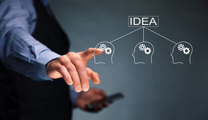 man holding phone with idea and gears icon