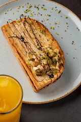 Kiwi, banana and chocolate toast with fresh orange juice.