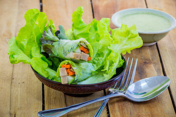 Fresh vegetable salad roll with salad dressing
