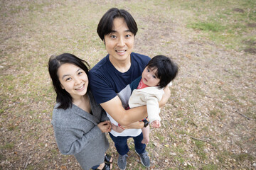 Japanese Family relaxing in the park with a newborn daughter