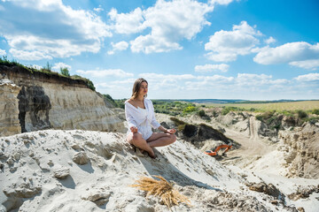 female tourist sit and relax after hard day in sandpit, canyon