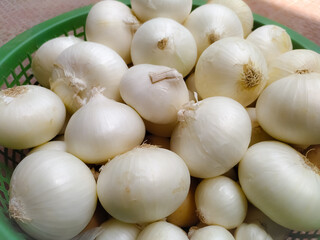 bulk of white onions in the marketplace, closeup