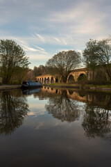 Fototapeta na wymiar Chirk aqueduct and viaduct on the Llangollen canal, on the border of England and Wales. With a barge narrowboat moored