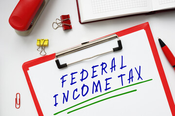 Business concept meaning FEDERAL INCOME TAX with phrase on the piece of paper.