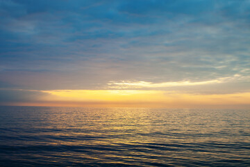 Naklejka na ściany i meble Amazing beach sunset with endless horizon. Horizontal. Selective focus.