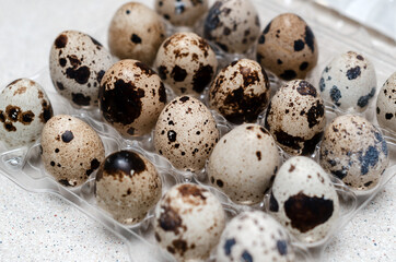 quail eggs in plastic packaging on the table