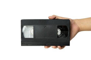 Video tape cassette VHS holding in hand.