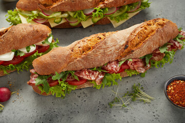 Fresh submarine sandwiches near herbs and spices