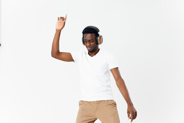 Naklejka premium African American in headphones gesturing with hands music technology fun