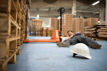 Injury at work. Warehouse worker after an accident in a warehouse.