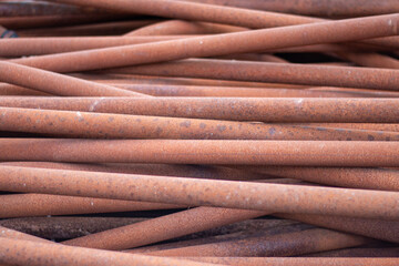 Old rusty iron pipes. Photo on the topic of recycling scrap metal or replacing old pipes.