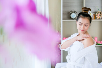 Asian woman relaxing while waiting for a spa massage.