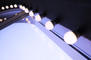 Lights in a row. Lamp hanging from the ceiling in the building. Arranged in a long line