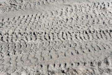 Tire tracks on the sand in desert. Sand texture background.