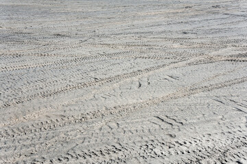 Tire tracks on the sand in desert. Sand texture background.