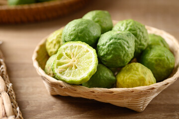 Fresh bergamot fruit in a basket on wooden table, Food ingredients and extract used for medicine, tea, perfumes and cosmetics