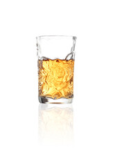 whiskey in shot glass on white background