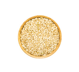 Organic brown rice in wooden bowl on white background, top view.