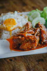 steamed pork and rice with A fried egg on wood table