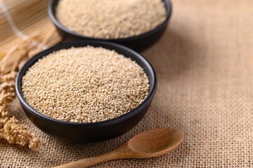 Brown quinoa seeds in a bowl with spoon, Edible seeds are high protein, Healthy food