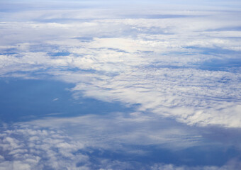 Fototapeta na wymiar Cloudy blue sky taken from the airplane.