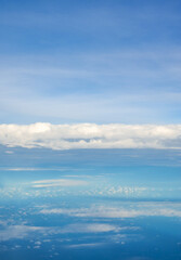 Naklejka na ściany i meble Blue sky and clouds view from airplane window.