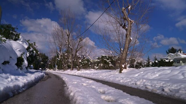 Footage of a road at Kifissia, Athens , Greece with have snow during Mideia  winter weather conditions, pedestal up shot. February 2020.