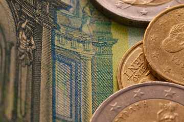 Fototapeta na wymiar Series of macro shots of euro coins. Close up of 100 euro bill with some coins on it as a background