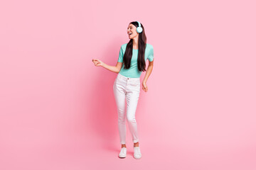 Full size photo of young attractive lovely happy positive girl in headphones dancing isolated on pink color background