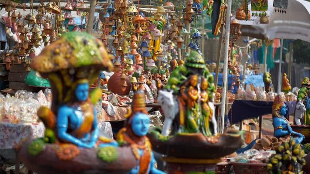 Tilt shot of a beautiful festive market of traditional handicrafts in Delhi/NCR  India. Attractive shot of Indian stalls with idols of Hindu gods  wind chimes and colorful showpieces out for sale