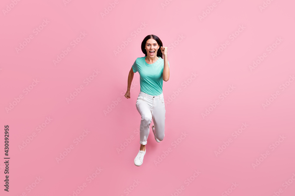 Poster full size photo of young beautiful happy positive crazy smiling cheerful girl running in air isolate