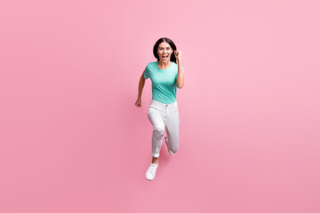 Fototapeta na wymiar Full size photo of young beautiful happy positive crazy smiling cheerful girl running in air isolated on pink color background
