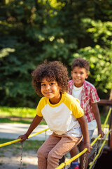 Brother and sister playing in nature. Focus is on little girl.