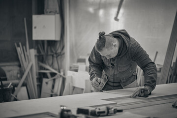 Woodwork and furniture making. Joinery, woodworking and furniture making, professional carpenter cutting wood in carpentry shop, industrial concept.