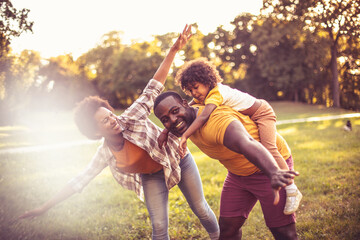  African American family having fun outdoors.